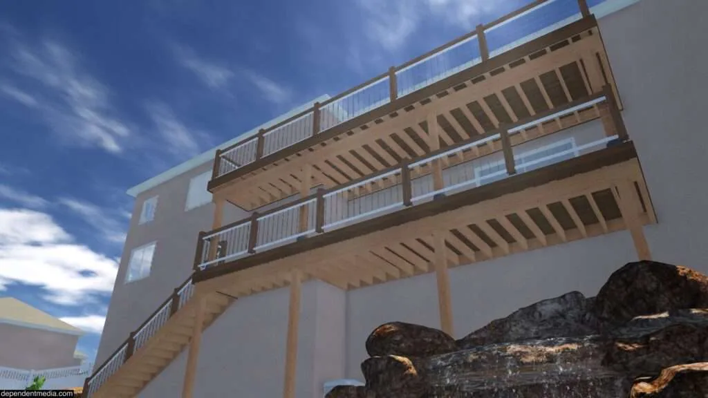 Modern multi-story residential building with stacked decks and white railings against blue sky with rocky foreground