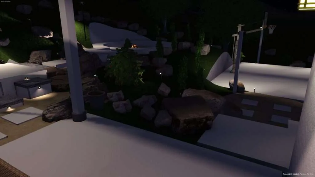 Modern nighttime backyard with illuminated white surfaces, rocks, evergreen plants, and a central structural column